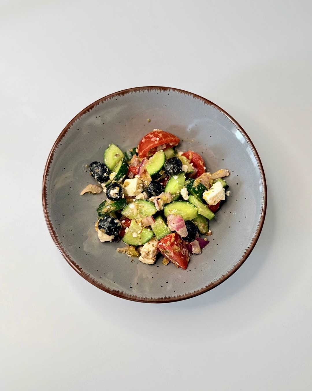 Friss görög saláta uborkával, paradicsommal, feta sajttal és fekete olívabogyóval.