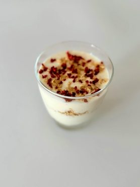 Krémes citromos sajttorta pohárdesszert zabpelyhes morzsával rétegezve, friss citromhéjjal díszítve.