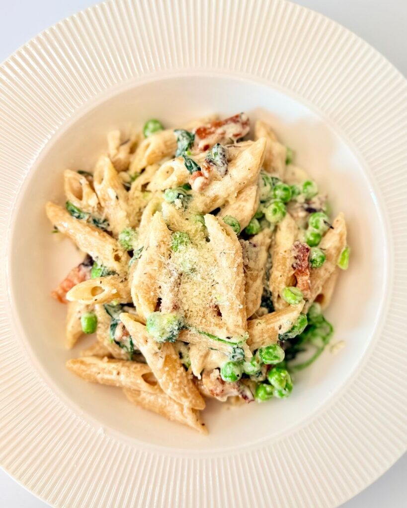 Krémes, tejszínes teljes kiőrlésű penne kolozsvári szalonnával, zöldborsóval, bébi spenóttal és reszelt parmezánnal.